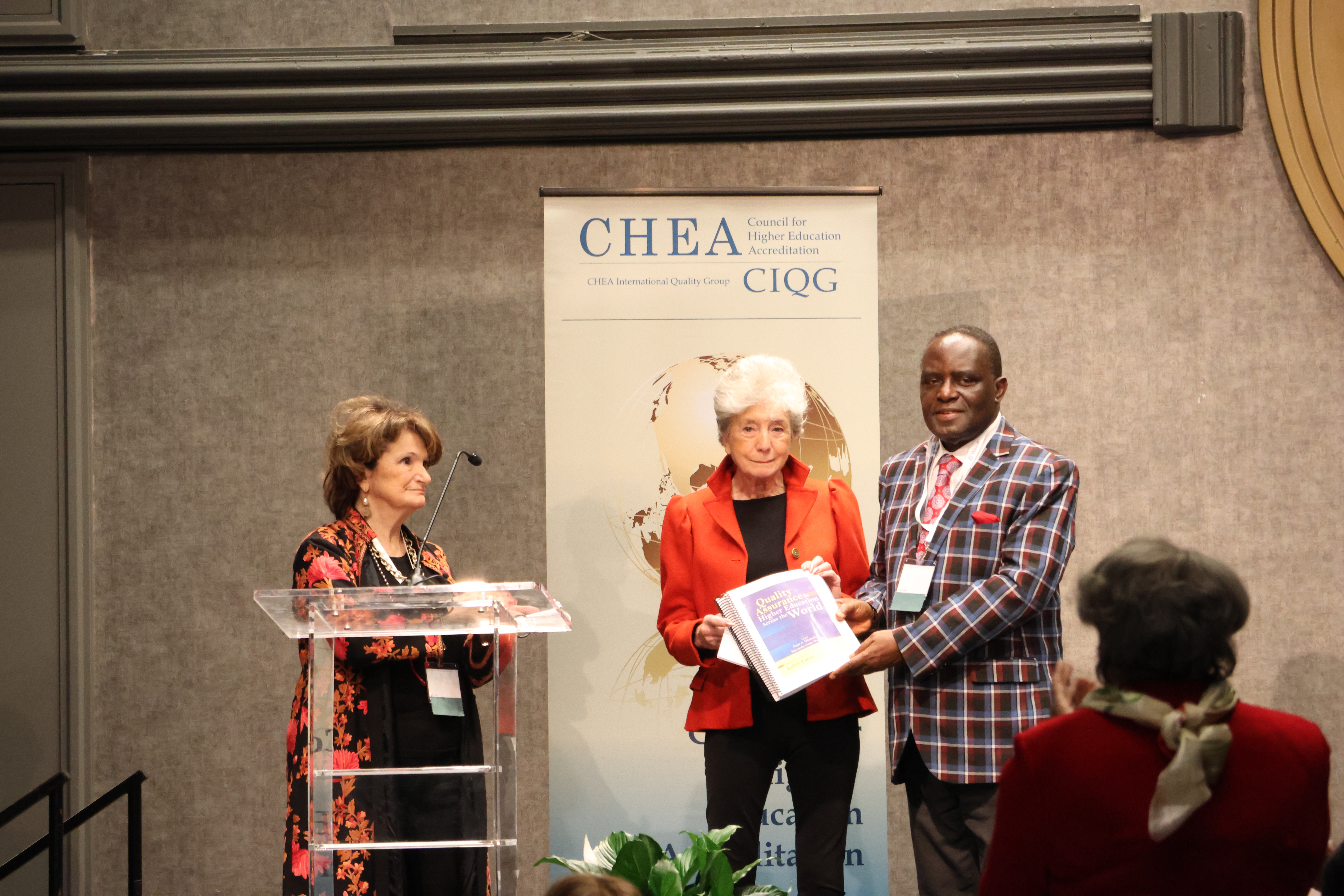 Judith Eaton presented with book at CHEA 2023 conference